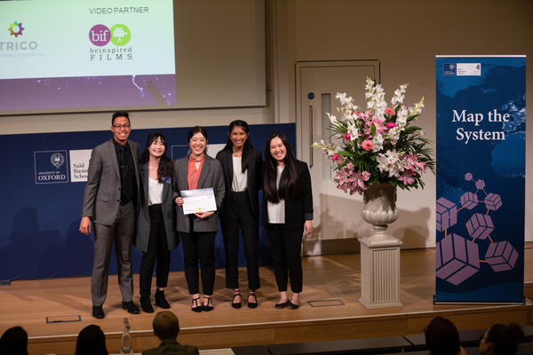 Bridging the Gap, Simon Fraser University team holding Map the System 2018 prize award